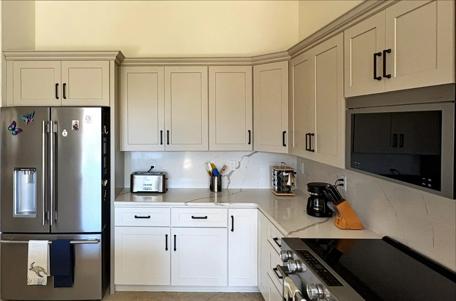 Remodeled kitchen with white shaker cabinets and quartz countertops by Stonebridge in Marion County, FL